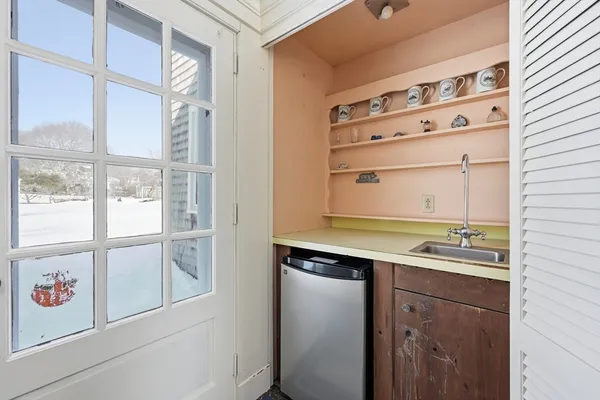 a spacious bedroom with a bed a window and dresser