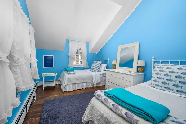 a bathroom with a toilet a sink a mirror a window and vanity