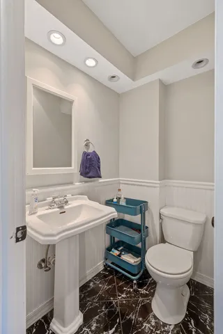 a room with stainless steel appliances kitchen island granite countertop a refrigerator and cabinets