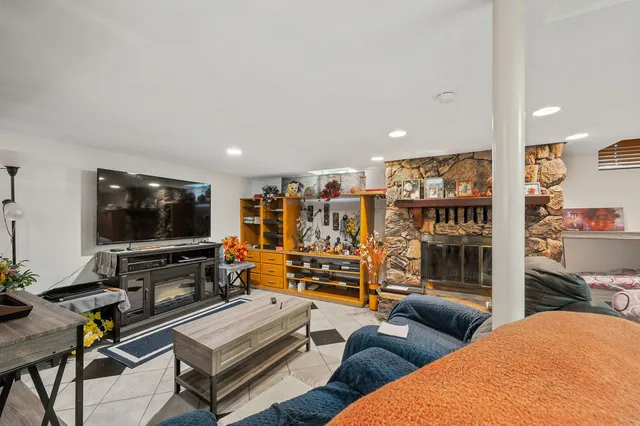 a bedroom with furniture and a floor to ceiling window