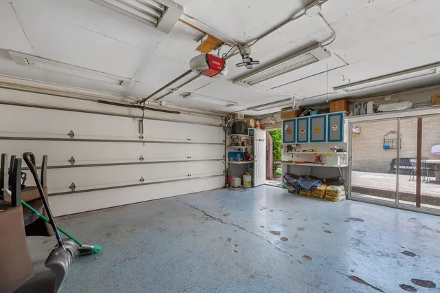 a view of a patio with table and chairs with a barbeque grill and plants