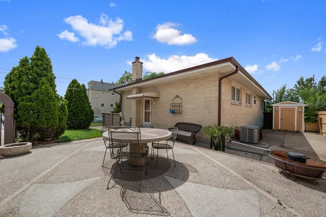 a house view with a sitting space fire pit and outdoor space
