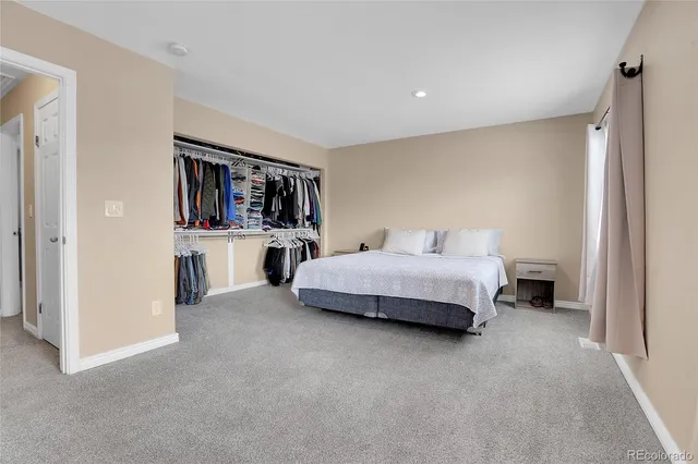 a bedroom with a bed and a book shelf