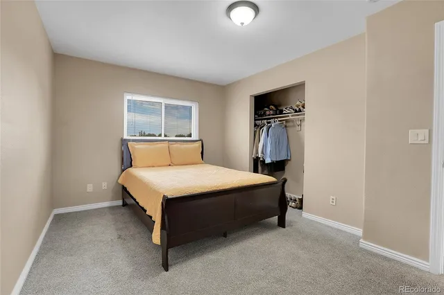 a bedroom with a bed and a tv