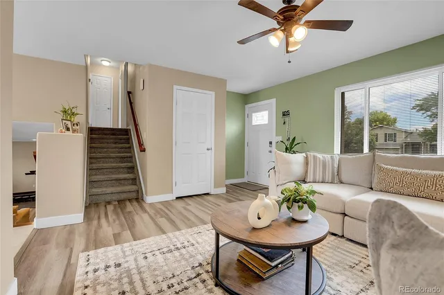 a living room with furniture and a wooden floor