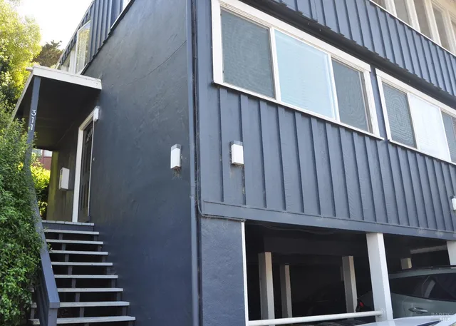 an aerial view of a house with a yard and balcony