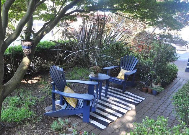 a wooden bench sitting in the middle of a garden