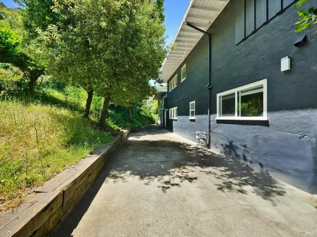 a view of a backyard with large trees
