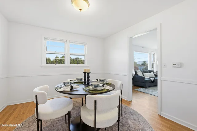 a view of a dining room with furniture window and wooden floor