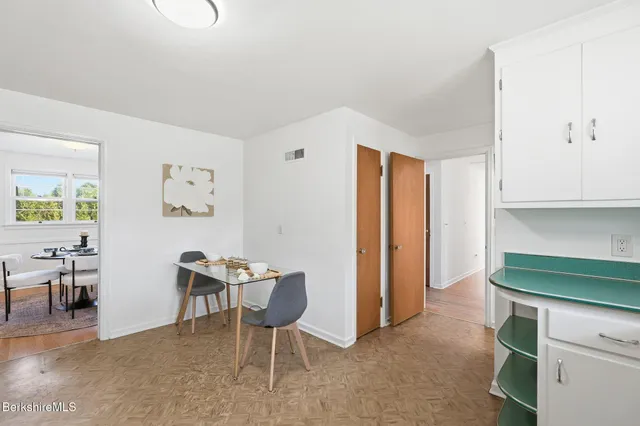 a dining room with furniture and a window