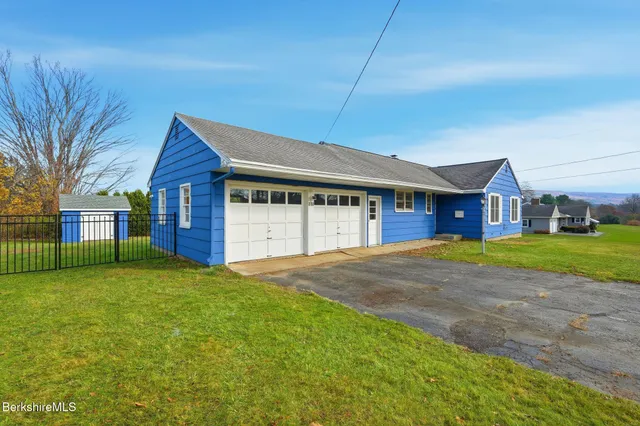 a view of an house with backyard and space