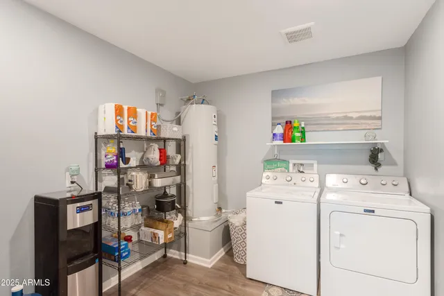 a room with a refrigerator and a wooden floor