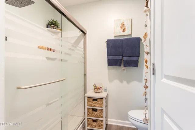 a bathroom with a toilet a sink and a shower