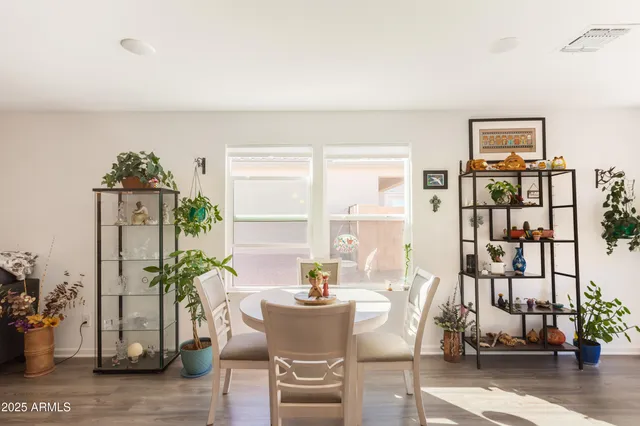 a dining room with furniture and wooden floor