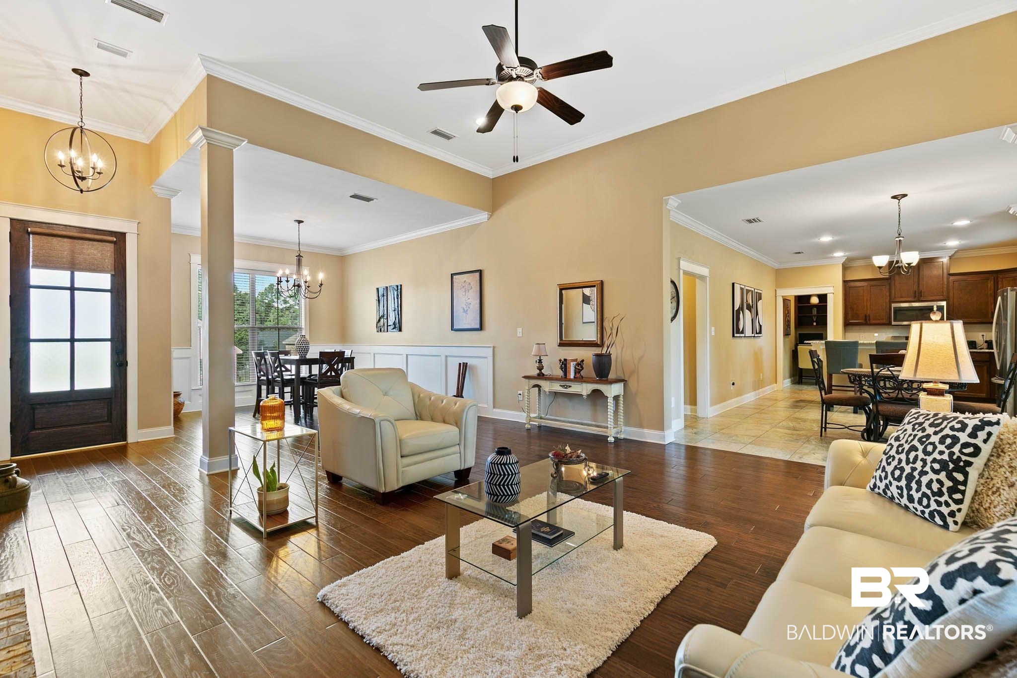 19740 Bunker Loop Fairhope, AL 36532 - Photo 7 of 33 Living room featuring a chandelier, crown molding, wood finished floors, and ceiling fan