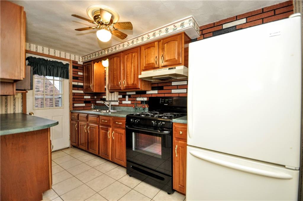 1944 Bower Hill Road Pittsburgh, PA 15243 - Photo 14 of 23 a kitchen with stainless steel appliances granite countertop a stove a sink and a refrigerator