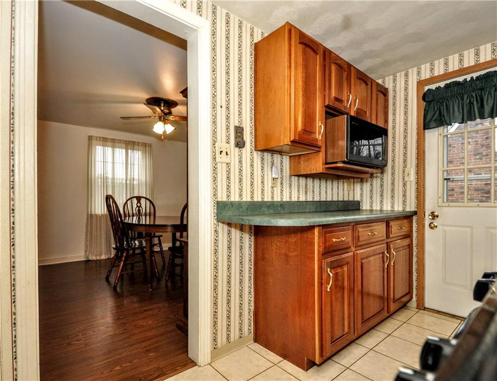 1944 Bower Hill Road Pittsburgh, PA 15243 - Photo 15 of 23 a kitchen with stainless steel appliances granite countertop a kitchen island a stove a sink a dining table and chairs