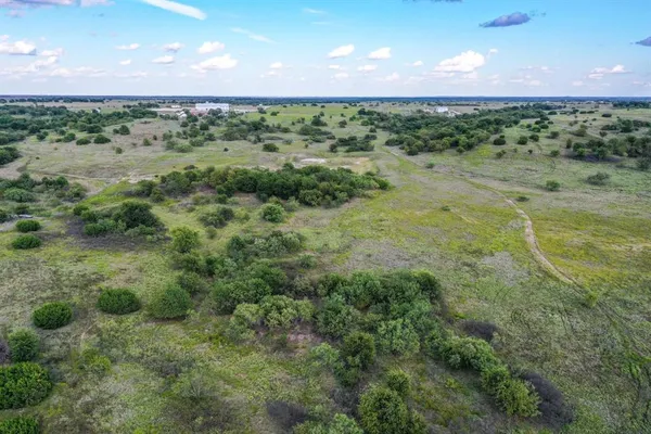 a view of a field with an ocean