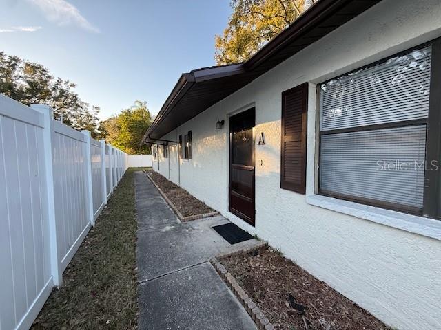 a view of a pathway of a house with wooden fence