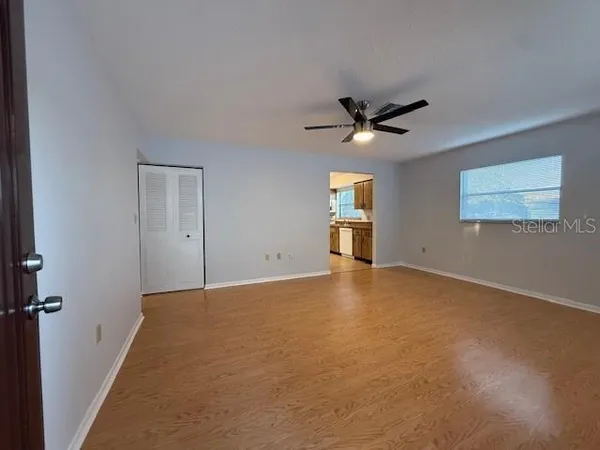 a view of a livingroom with a ceiling fan and window
