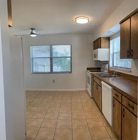 a kitchen with a sink cabinets and window