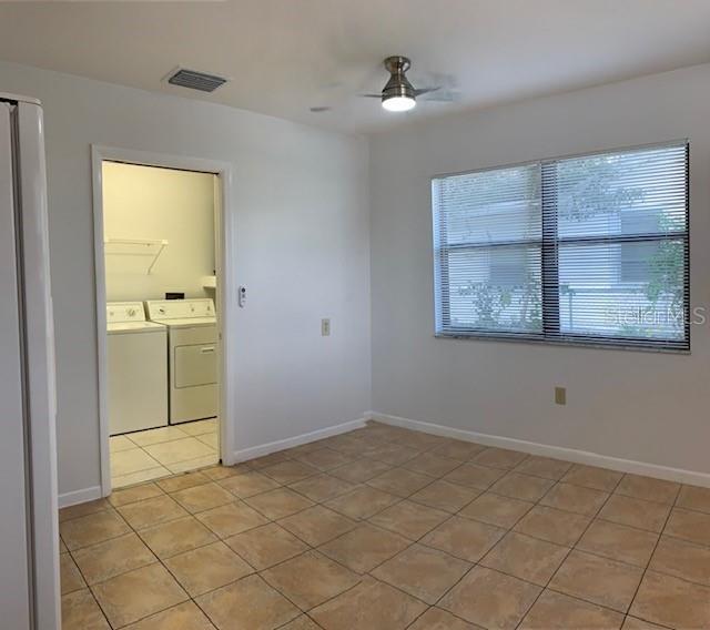 1029 10th Street Northwest, Unit A Largo, FL 33770 - Photo 8 of 21 an empty room with a empty space and windows