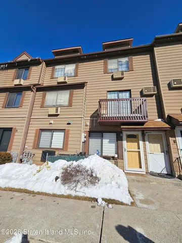 a view of a white house with large windows
