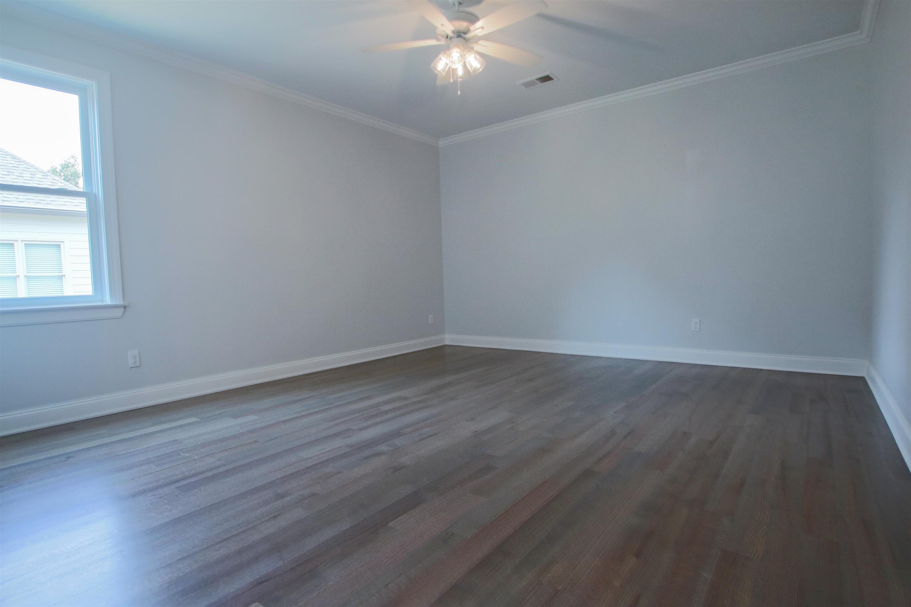 2611 Moore Road Germantown, TN 38138 - Photo 32 of 35 Empty room with ceiling fan, wood-type flooring, and ornamental molding
