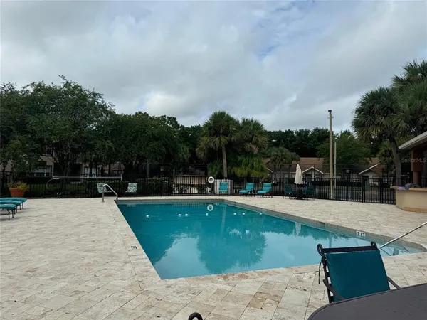 a view of a swimming pool with lounge chair