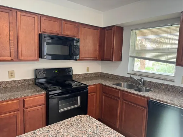 a kitchen with a sink stove and microwave