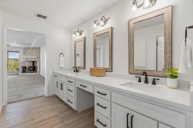 a bathroom with a sink a toilet and a mirror