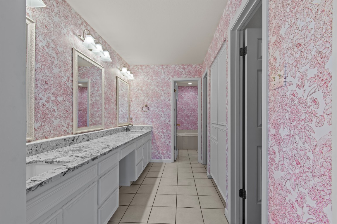 25048 River Road Spicewood, TX 78669 - Photo 14 of 33 a bathroom with a granite countertop sink and a mirror