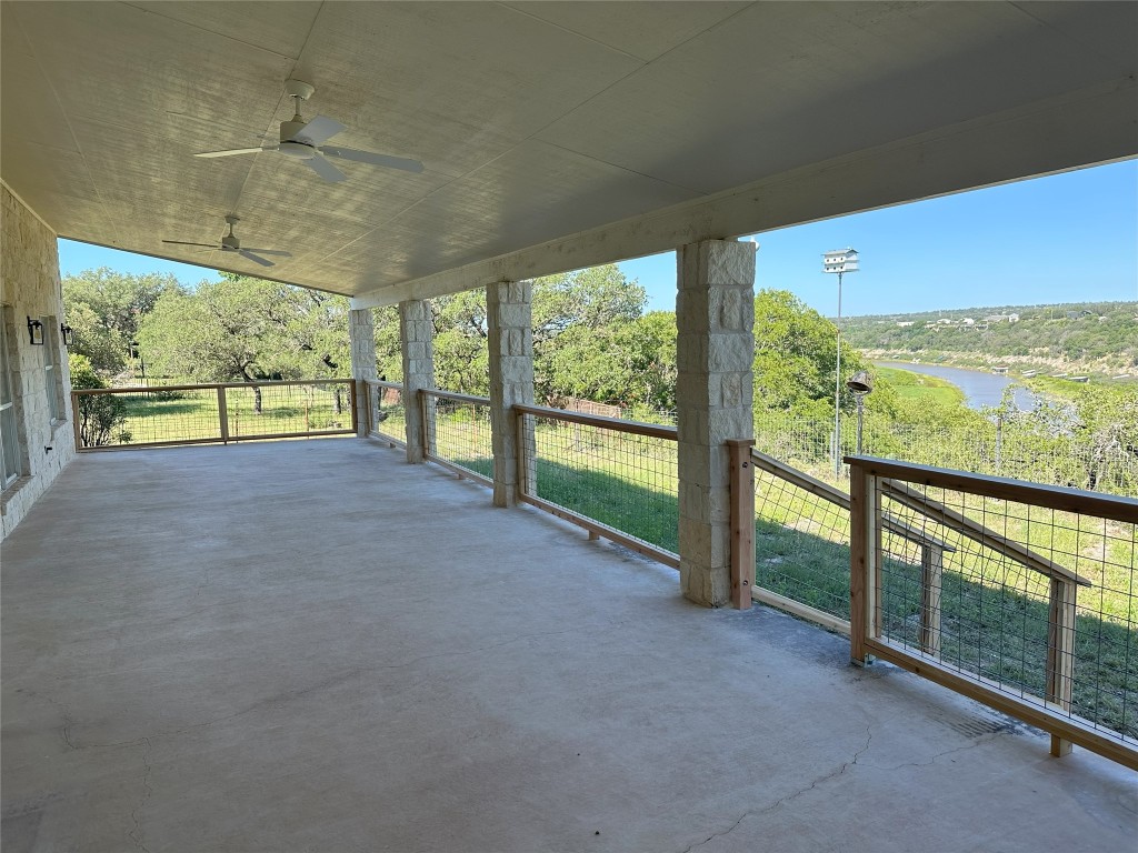 25048 River Road Spicewood, TX 78669 - Photo 19 of 33 a view of an empty room with a floor to ceiling window and an outdoor view