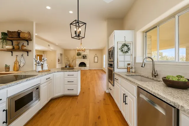a kitchen with a sink stove and cabinets