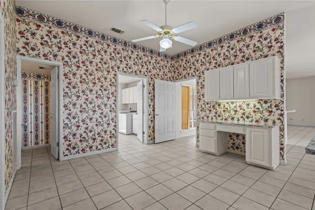 a kitchen with cabinets and window