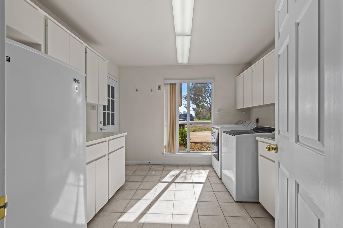 25048 River Road Spicewood, TX 78669 - Photo 10 of 33 a kitchen with cabinets and window