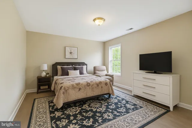 a bed room with bed and a television