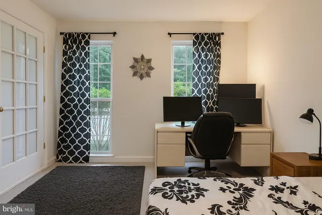 a view of a workspace with furniture and wooden floor