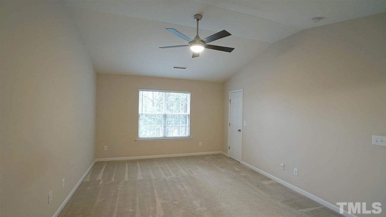 8311 Martello Lane Raleigh, NC 27613 - Photo 17 of 30 an empty room with a window and a fan