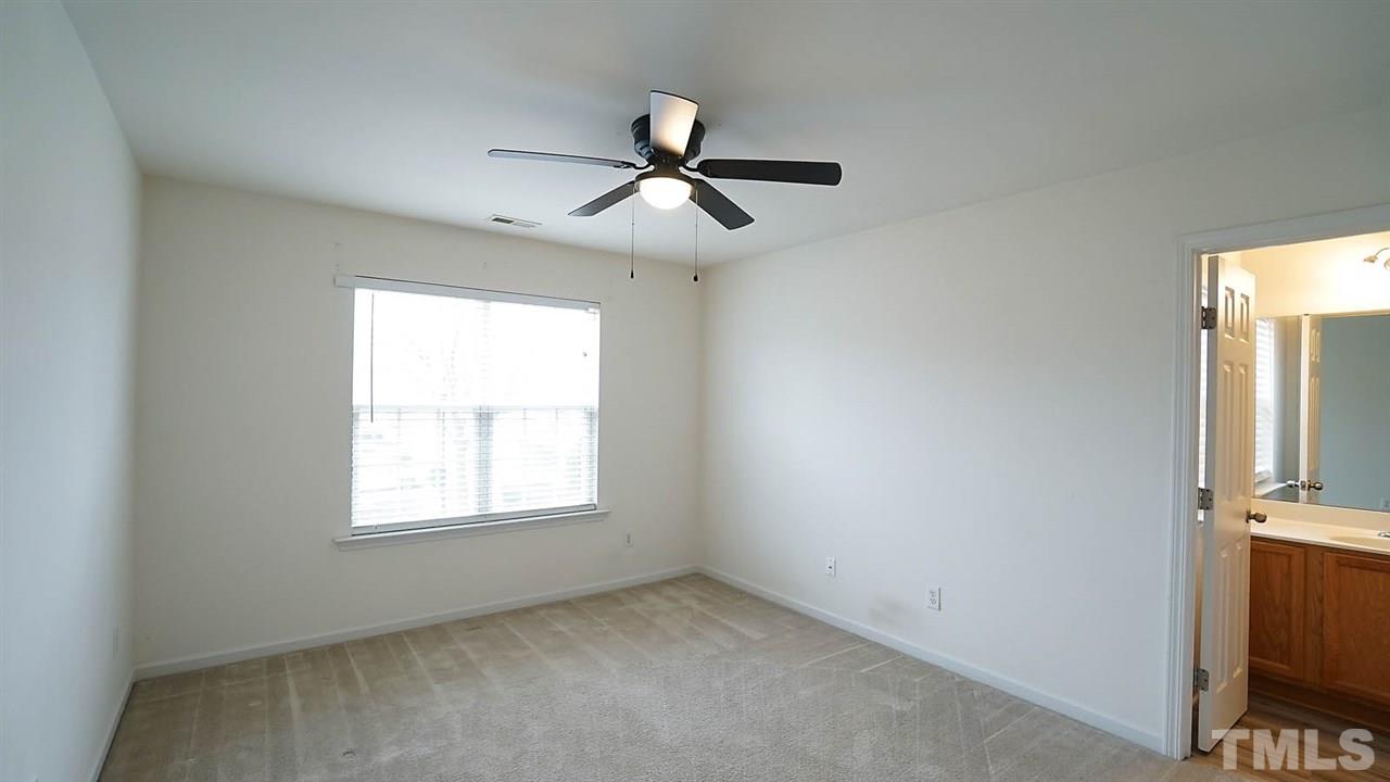 8311 Martello Lane Raleigh, NC 27613 - Photo 23 of 30 an empty room with windows and fan