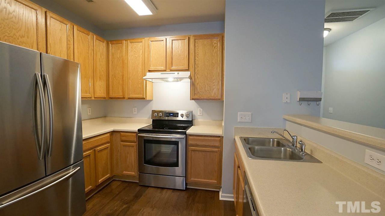 8311 Martello Lane Raleigh, NC 27613 - Photo 5 of 30 a kitchen with a sink stove and refrigerator