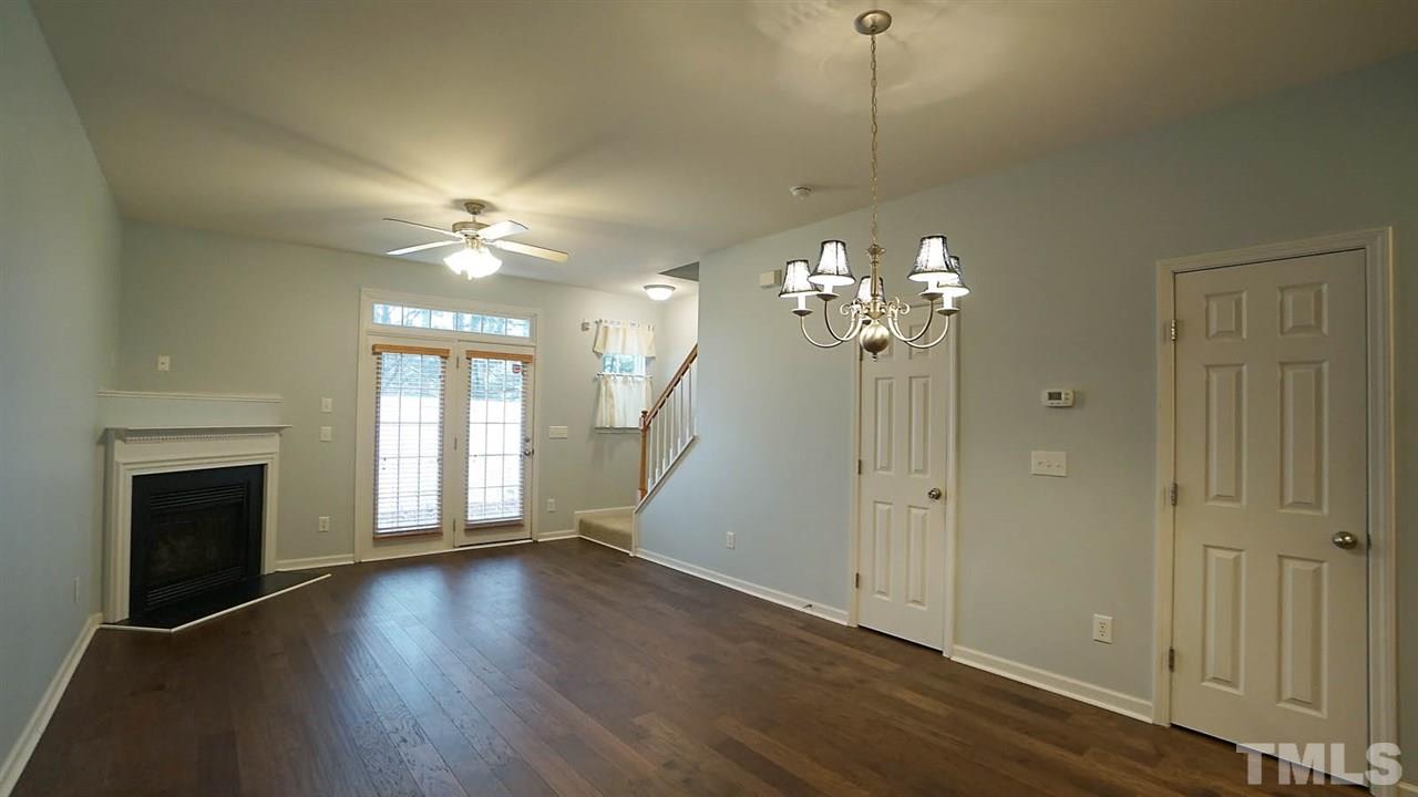 8311 Martello Lane Raleigh, NC 27613 - Photo 9 of 30 a view of a livingroom with a fireplace window and wooden floor