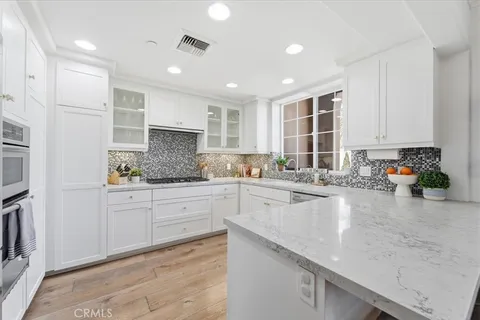 a bathroom with a granite countertop toilet sink and mirror