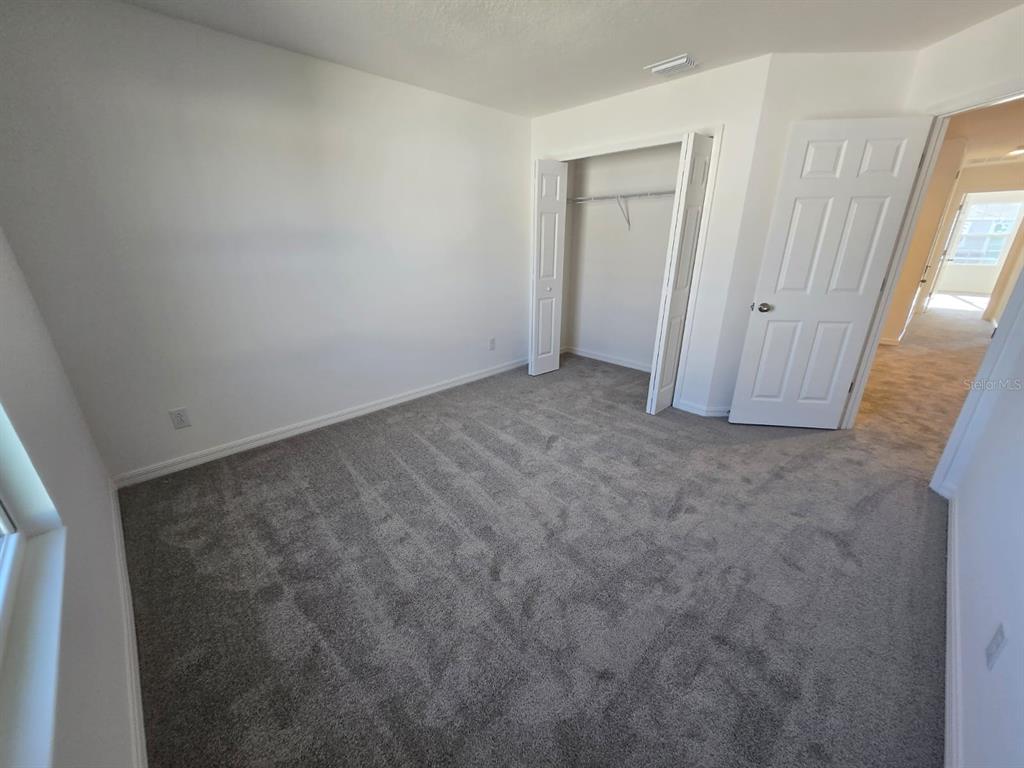 4827 Noble Cypress Street Kissimmee, FL 34746 - Photo 16 of 29 an empty room with a mirror