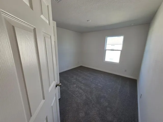 a view of a hallway with a wooden floor