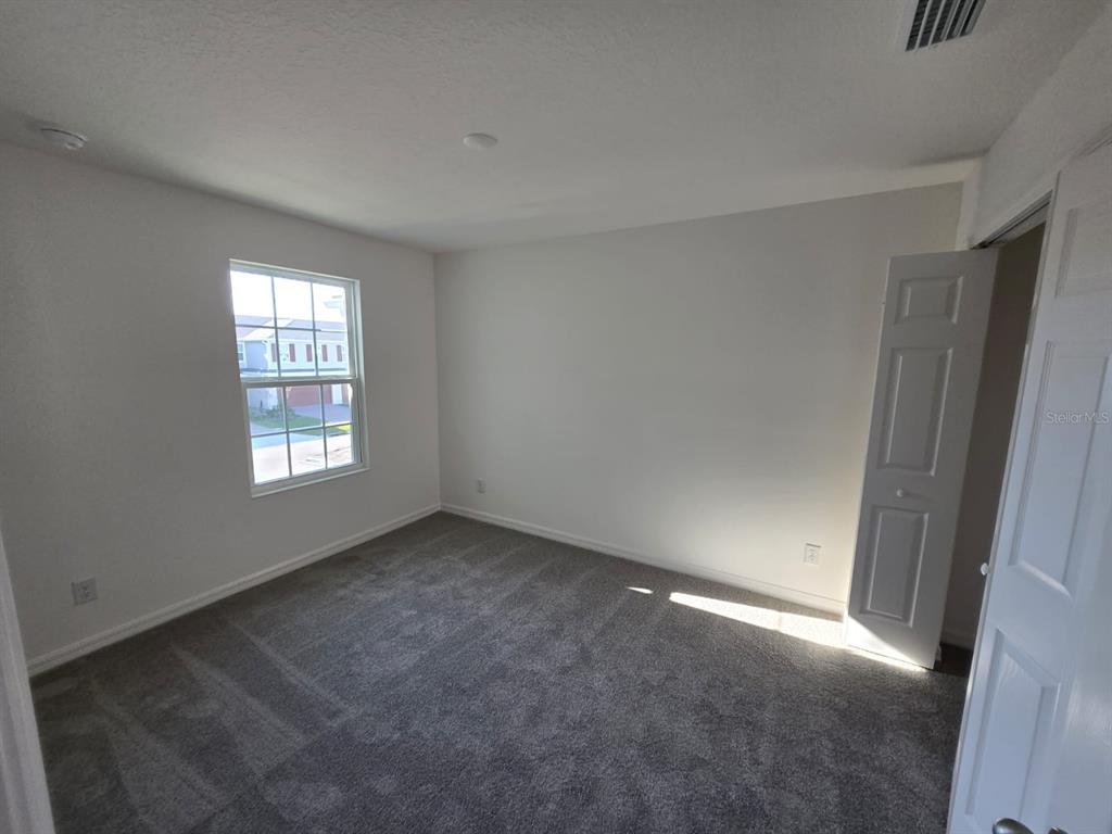 4827 Noble Cypress Street Kissimmee, FL 34746 - Photo 22 of 29 an empty room with windows