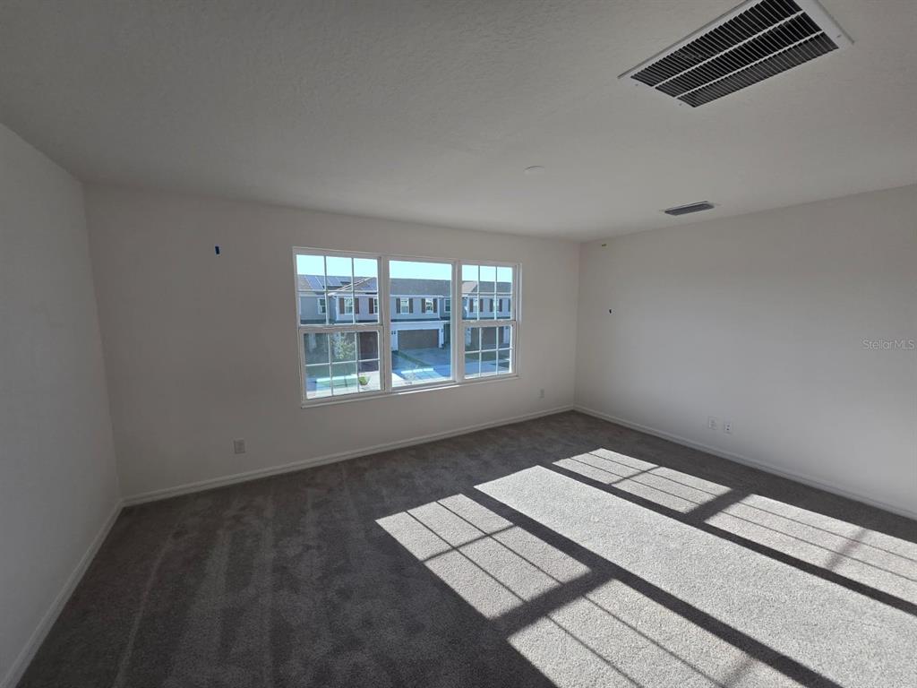 4827 Noble Cypress Street Kissimmee, FL 34746 - Photo 25 of 29 a view of an empty room with a window