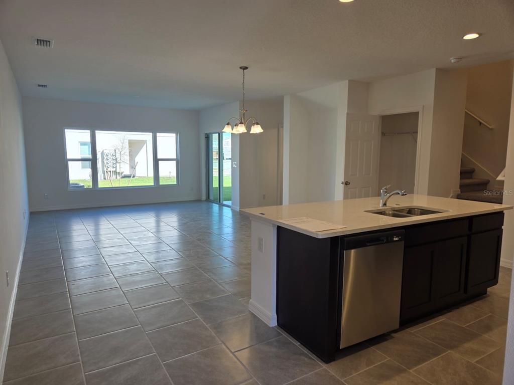 4827 Noble Cypress Street Kissimmee, FL 34746 - Photo 4 of 29 a bathroom with a sink a vanity a mirror and a bathtub
