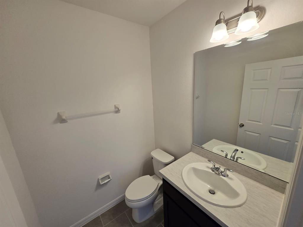 4827 Noble Cypress Street Kissimmee, FL 34746 - Photo 8 of 29 a bathroom with a sink toilet and a mirror