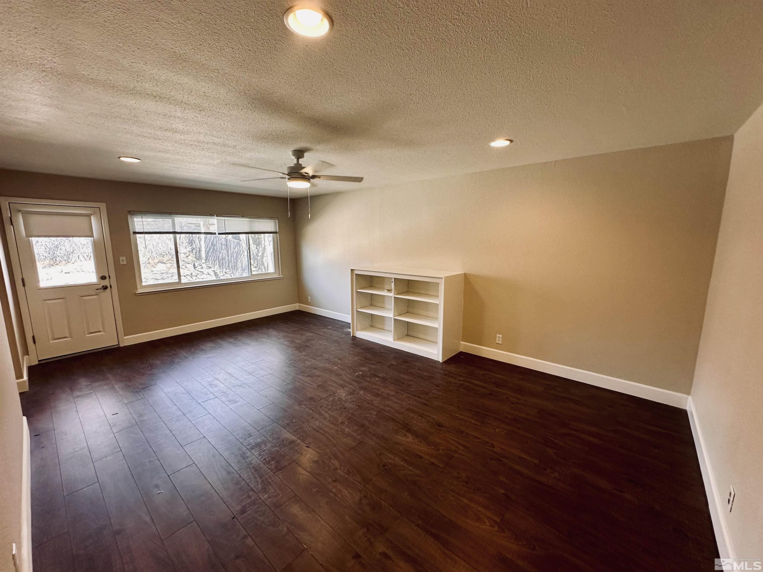 1945 Gridley Avenue Reno, NV 89503 - Photo 11 of 27 an empty room with wooden floor and windows